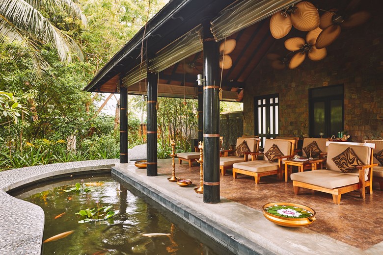 spa chairs overlooking pond in maldives jungle setting