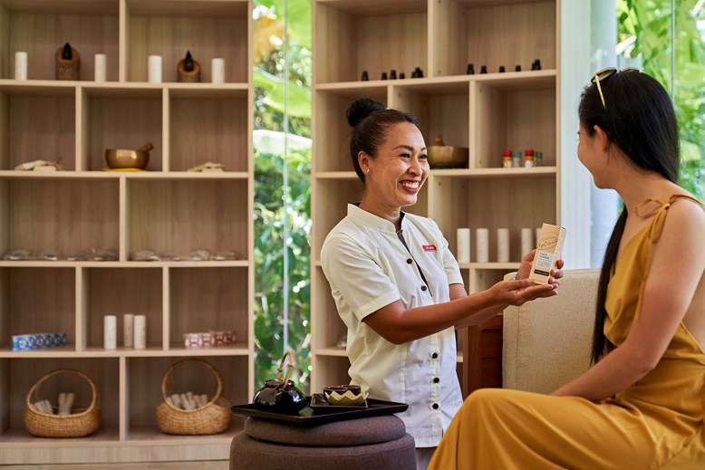 massage host showing products to woman