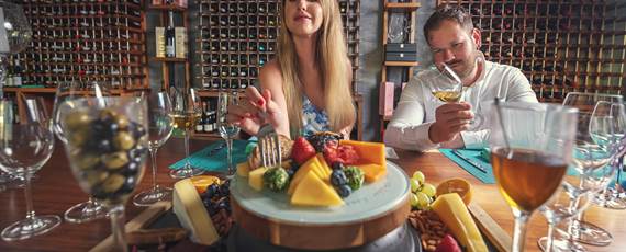 Couple eating cheese platter